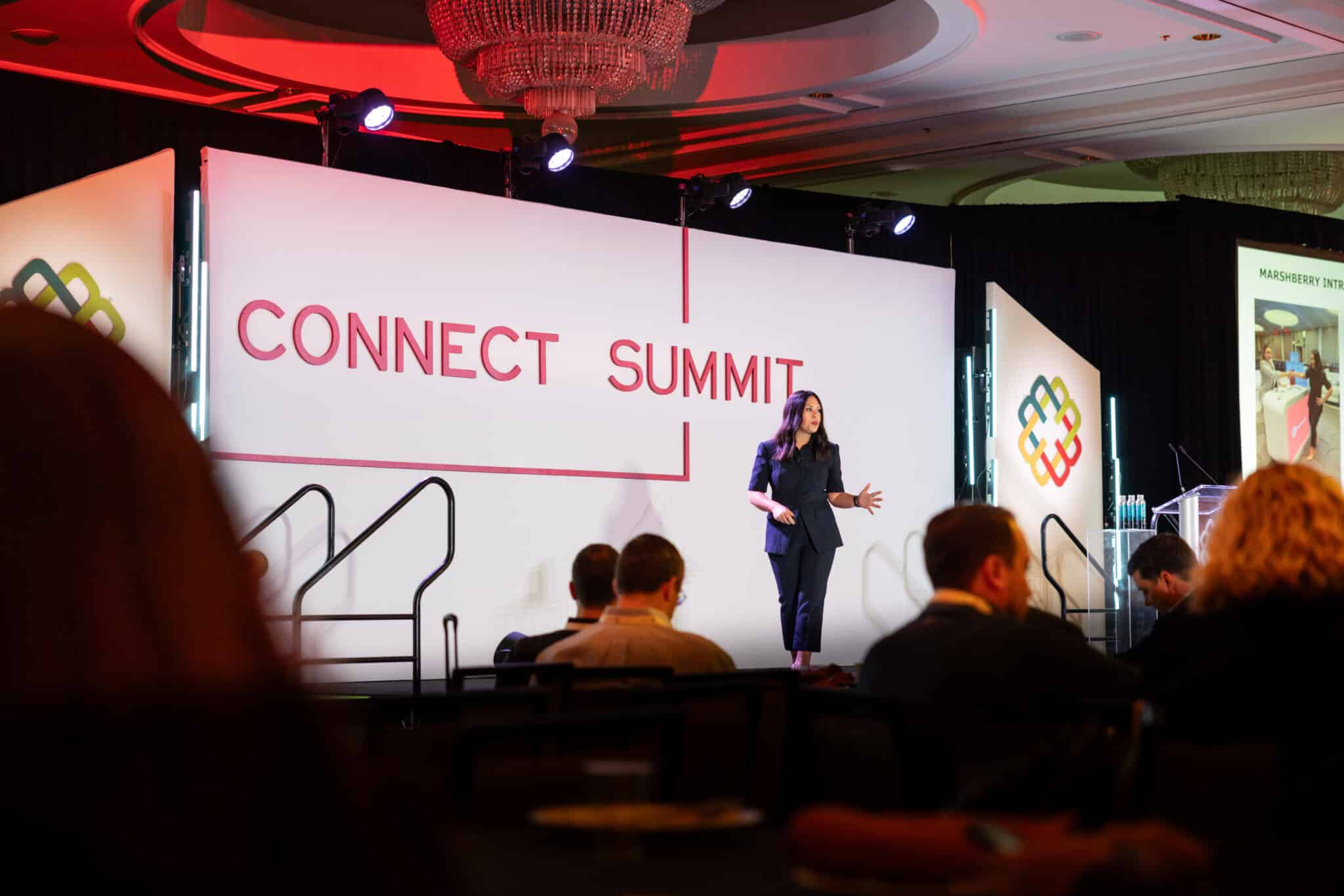 Woman presenting on stage at Marshberry event