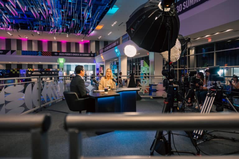 Two people discussing at a podcast set created by Colortone